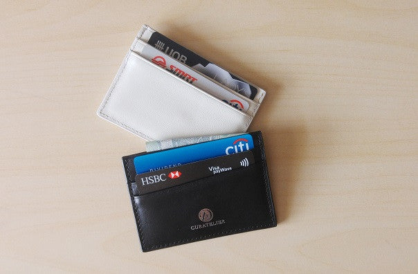 Front and back views of Curatelier self-manufactured collection of handmade genuine leather cardholder wallet with cards inserted for illustration.